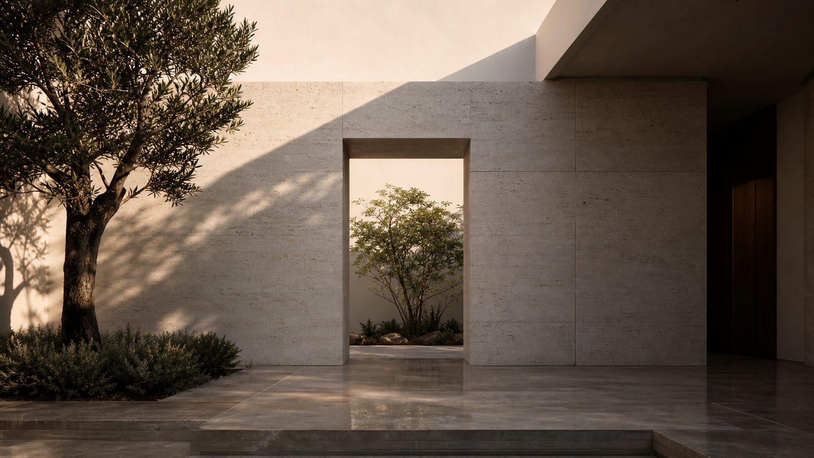 Minimal courtyard house exterior with pale masonry and a small tree
